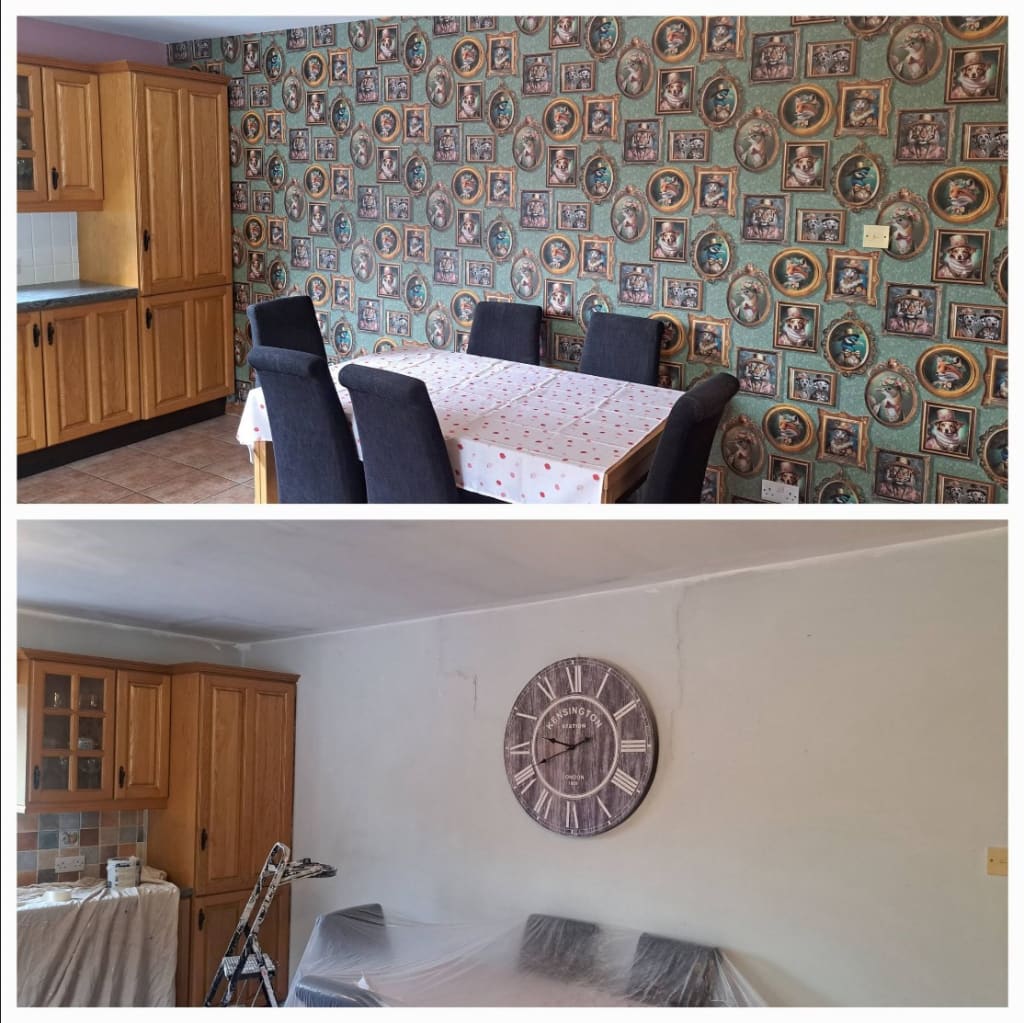 Split photograph of a dining room. The upper half shows a finished wall of green wallpaper patterned with framed animal portraits, beside a dining table. The lower half shows that wall earlier, pale and unpapered, with chairs under plastic and a stepladder.